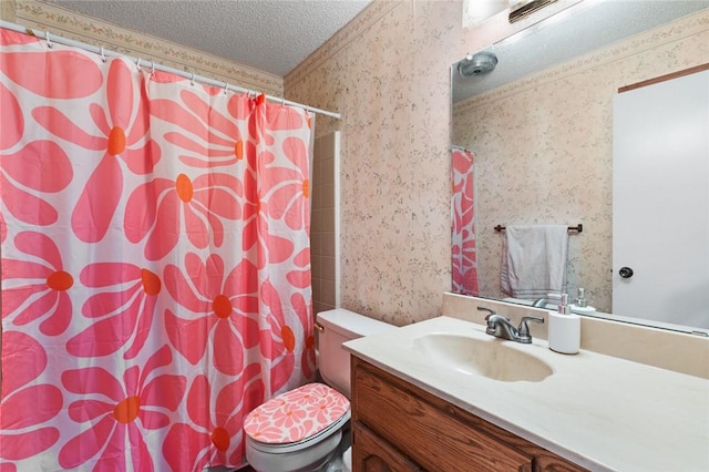 bathroom with vanity, a textured ceiling, and toilet