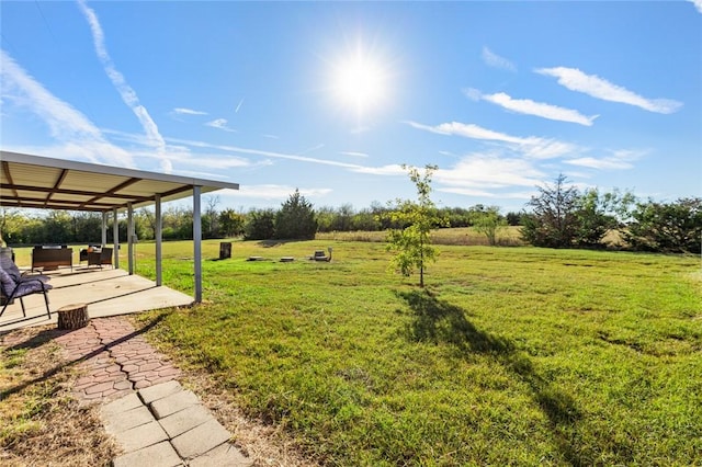 view of yard with a rural view and a patio