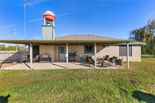 back of property featuring a yard, an outdoor living space, and a patio area