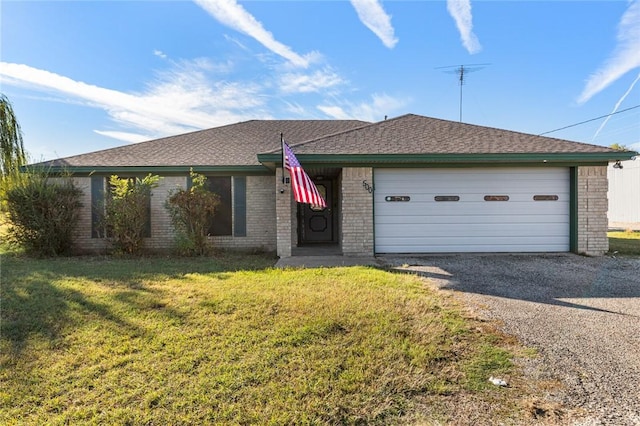 ranch-style home featuring a garage and a front lawn