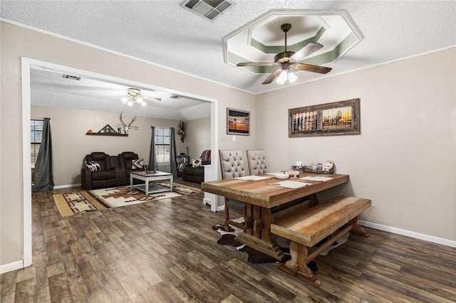 dining area with a textured ceiling, ceiling fan, dark hardwood / wood-style flooring, and crown molding