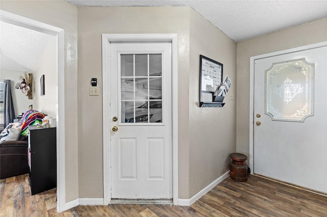 foyer featuring dark hardwood / wood-style flooring and a textured ceiling