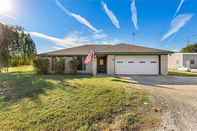 single story home with a front yard and a garage