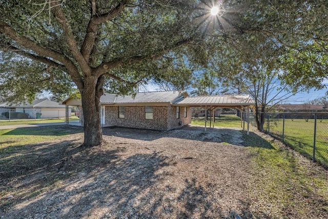 view of front of house with a front lawn and a carport