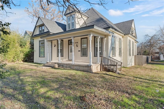 cape cod house with a porch and a front yard