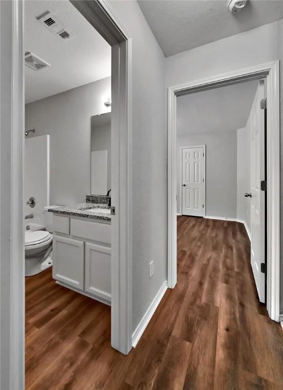 hallway with dark hardwood / wood-style floors and sink