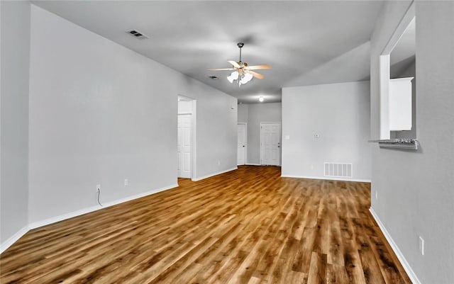 unfurnished living room featuring hardwood / wood-style flooring and ceiling fan