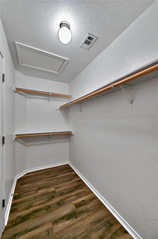 spacious closet featuring dark hardwood / wood-style floors