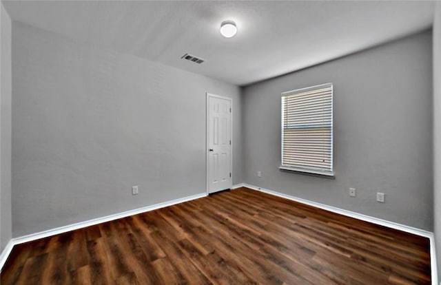 unfurnished room featuring dark hardwood / wood-style floors