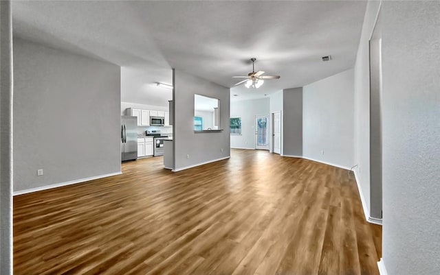 unfurnished living room featuring hardwood / wood-style floors and ceiling fan