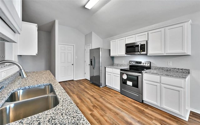 kitchen with white cabinets, light stone countertops, sink, and appliances with stainless steel finishes