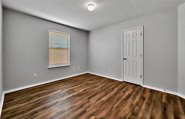 spare room featuring dark hardwood / wood-style floors