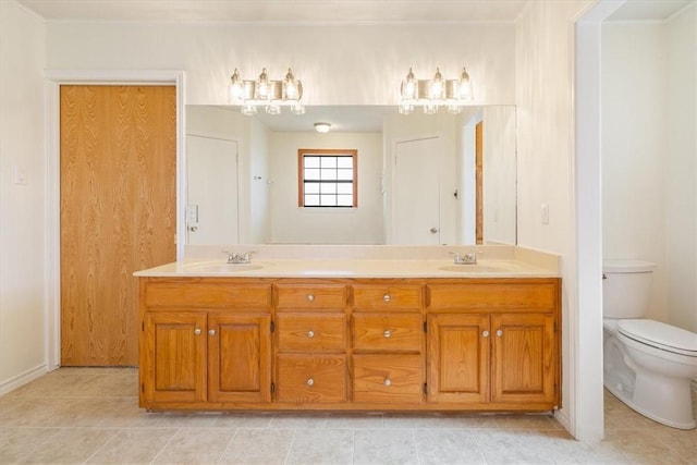 bathroom featuring vanity, tile patterned floors, and toilet