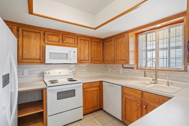 kitchen featuring tasteful backsplash, white appliances, light tile patterned flooring, and sink