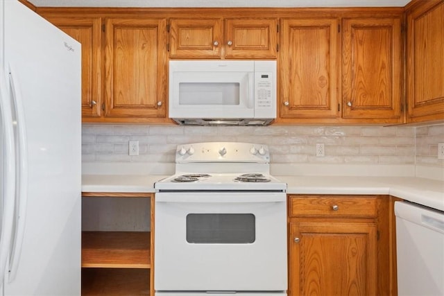 kitchen with tasteful backsplash and white appliances