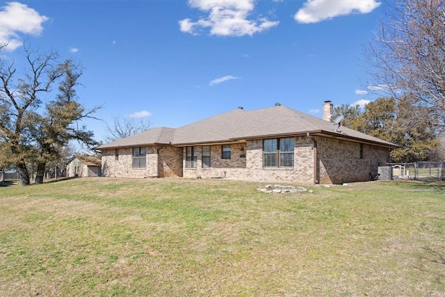 rear view of property featuring a yard