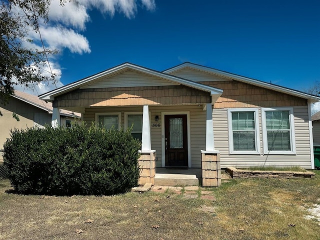 view of front of house with a porch and a front lawn