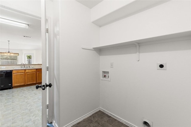 washroom featuring hookup for an electric dryer, washer hookup, a notable chandelier, and sink