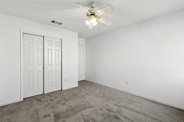 unfurnished bedroom featuring carpet flooring, ceiling fan, and a closet