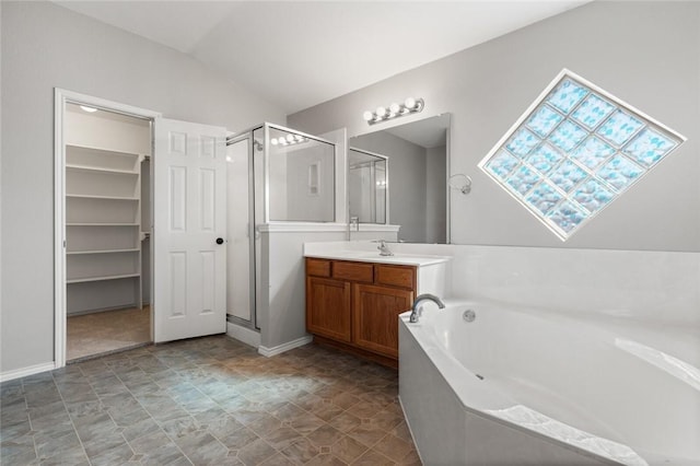 bathroom featuring vanity, vaulted ceiling, and separate shower and tub