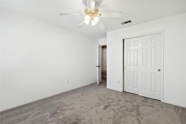 unfurnished bedroom featuring carpet floors, a closet, and ceiling fan