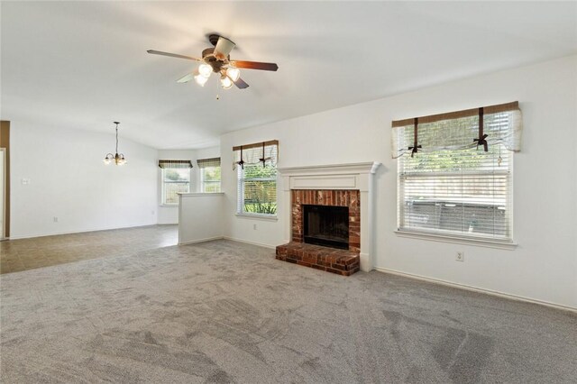 unfurnished living room featuring a fireplace, carpet floors, and ceiling fan