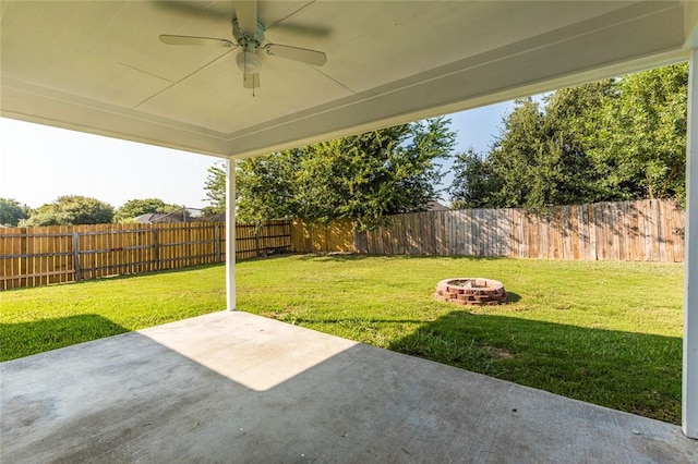 view of patio featuring ceiling fan and a fire pit