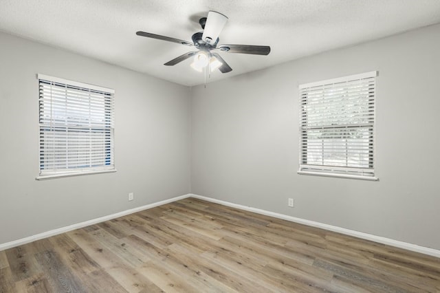 unfurnished room with ceiling fan, a textured ceiling, and light hardwood / wood-style flooring