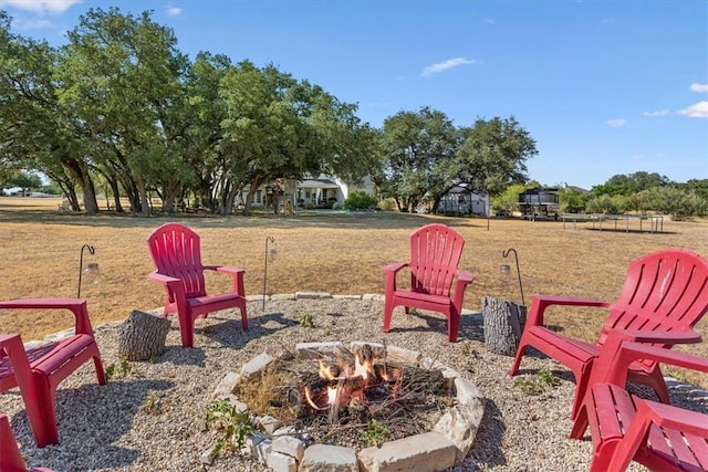 view of yard with a fire pit