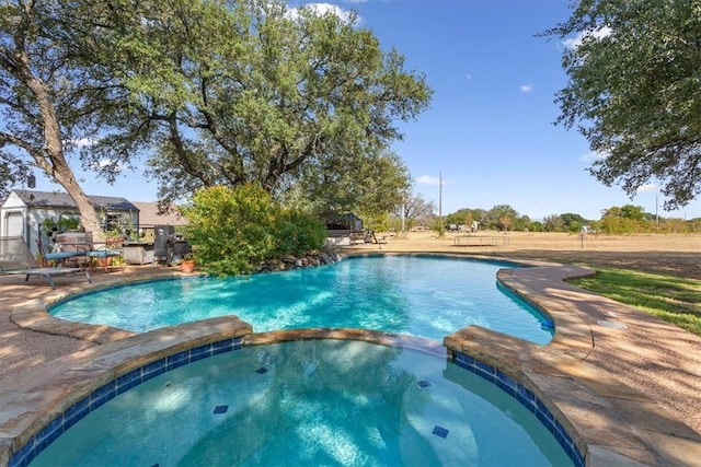 view of pool featuring a patio and a pool with connected hot tub