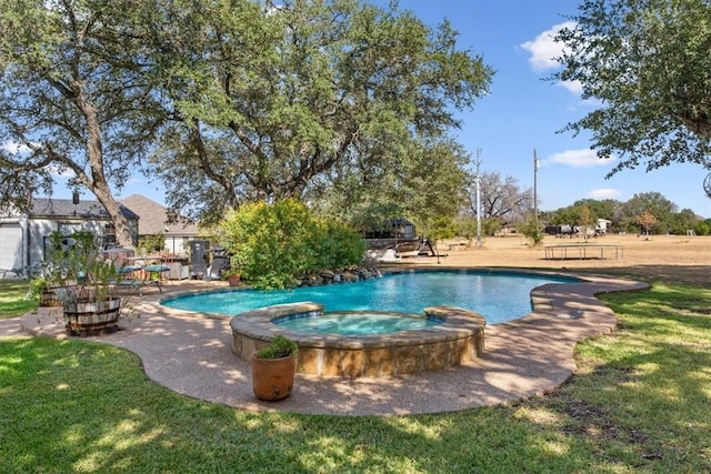 view of swimming pool with a lawn and a pool with connected hot tub