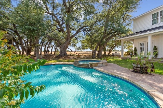 view of swimming pool with a patio and a pool with connected hot tub