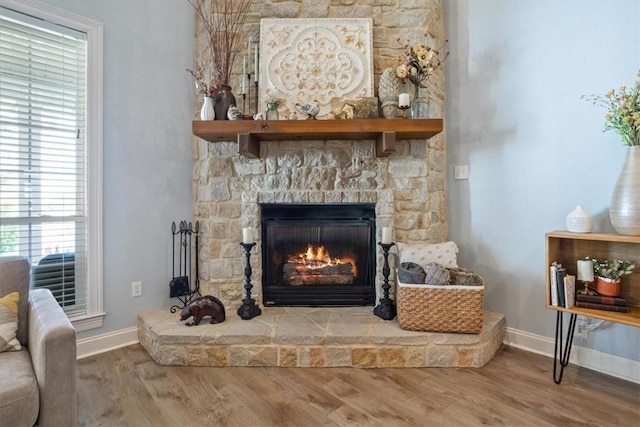 details with a fireplace, baseboards, and wood finished floors