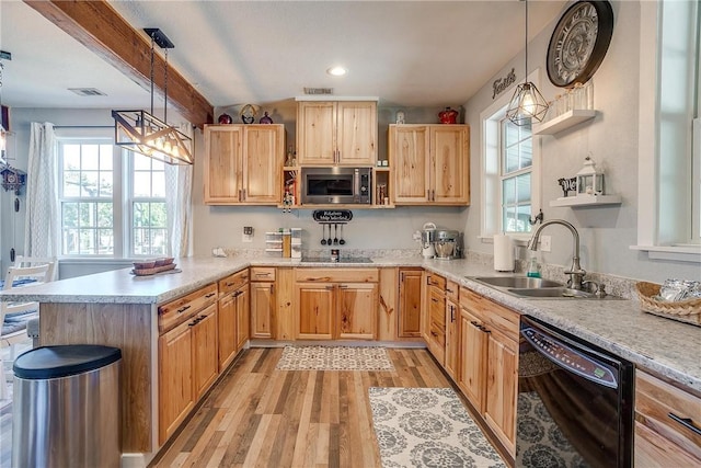 kitchen featuring light brown cabinets, black appliances, sink, light hardwood / wood-style flooring, and decorative light fixtures