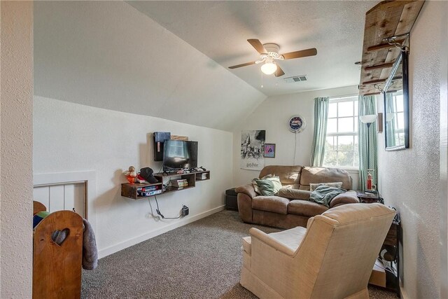 carpeted living room featuring a textured ceiling, ceiling fan, and lofted ceiling