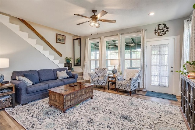 living room with ceiling fan and light hardwood / wood-style flooring