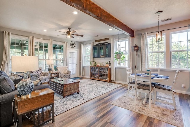 living room featuring hardwood / wood-style floors, ceiling fan, and beamed ceiling