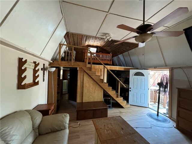 interior space with ceiling fan, hardwood / wood-style floors, and vaulted ceiling