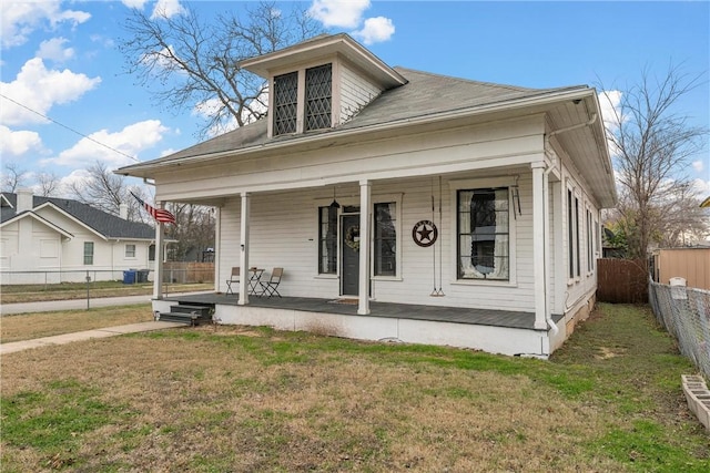 bungalow-style house featuring a porch and a front lawn