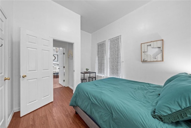 bedroom with wood-type flooring