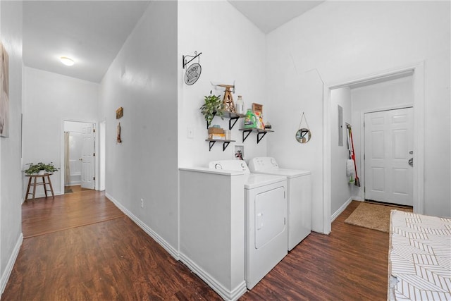 clothes washing area featuring washing machine and clothes dryer and dark hardwood / wood-style flooring