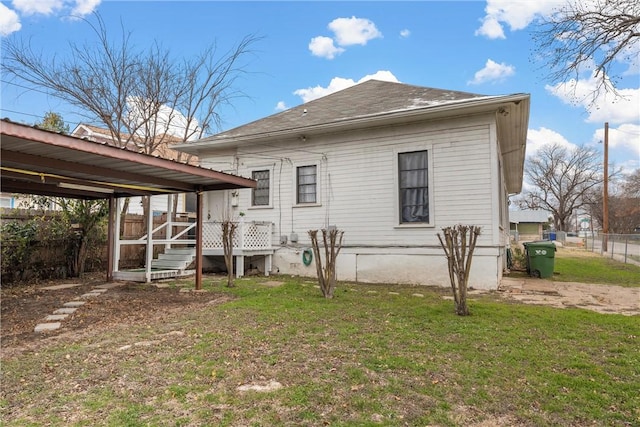 rear view of property with a yard