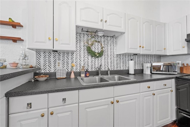 kitchen featuring sink, backsplash, and white cabinetry