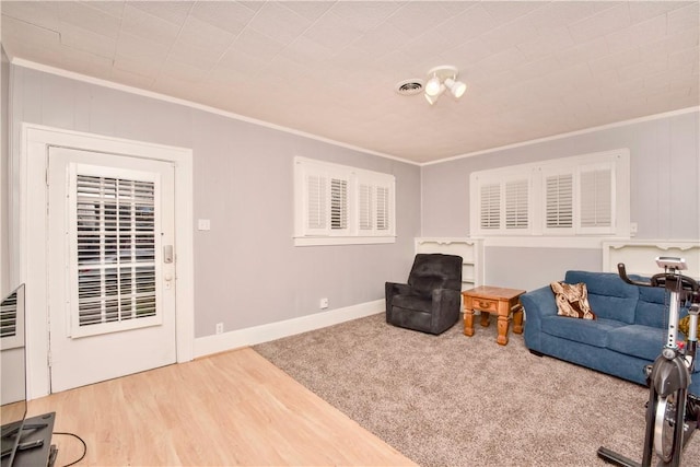 sitting room featuring hardwood / wood-style flooring and ornamental molding