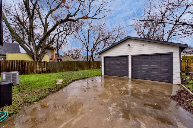 garage featuring a lawn and central air condition unit