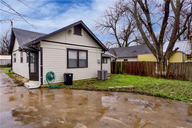 rear view of property with a patio area and central air condition unit