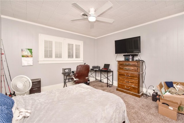 carpeted bedroom with ceiling fan and ornamental molding