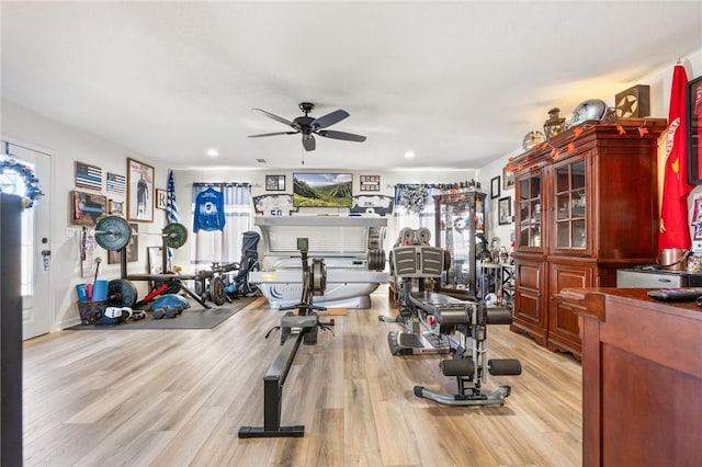 workout area featuring ceiling fan and light hardwood / wood-style floors