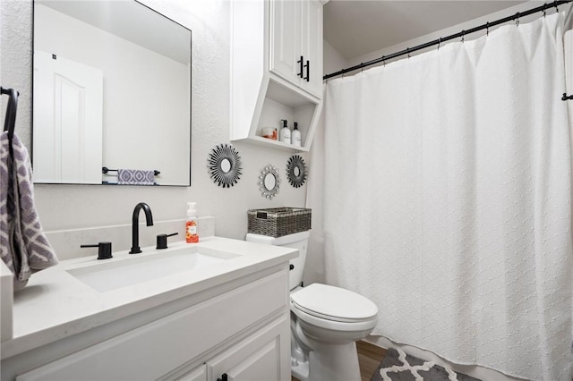 bathroom featuring vanity, toilet, and wood-type flooring