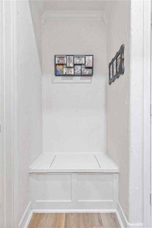 mudroom featuring light wood-type flooring and ornamental molding